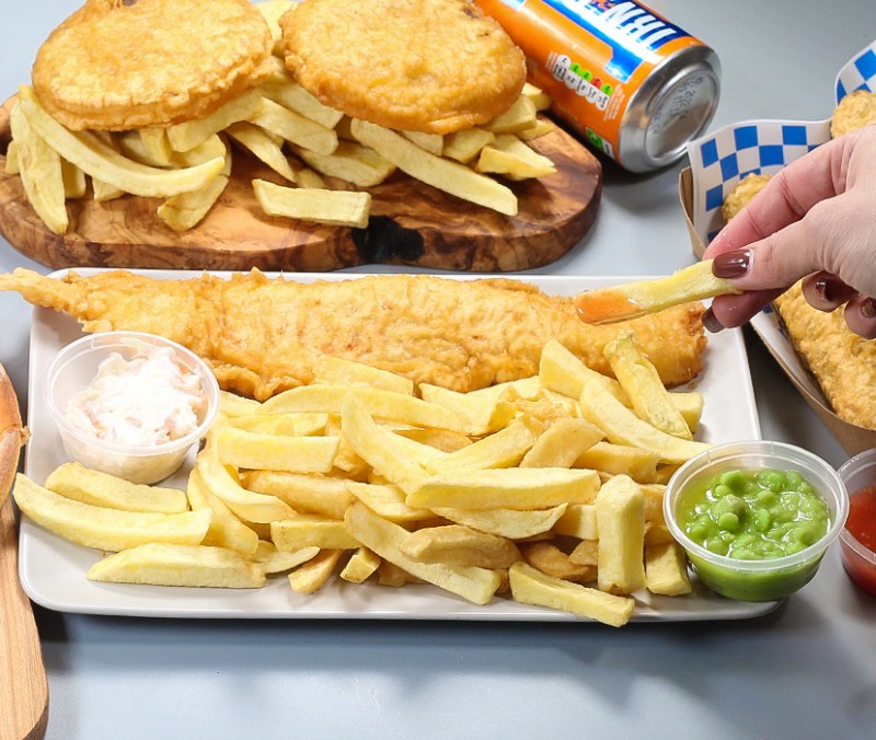 fish & chips with lemon & sauce in a newspaper served at Marini's Takeaway Ladywell takeaway